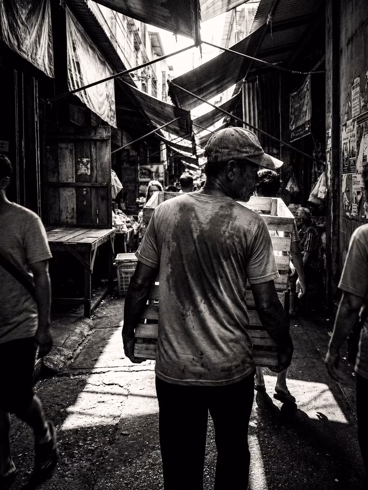 Monochrome view through a narrow Bangkok market alley
