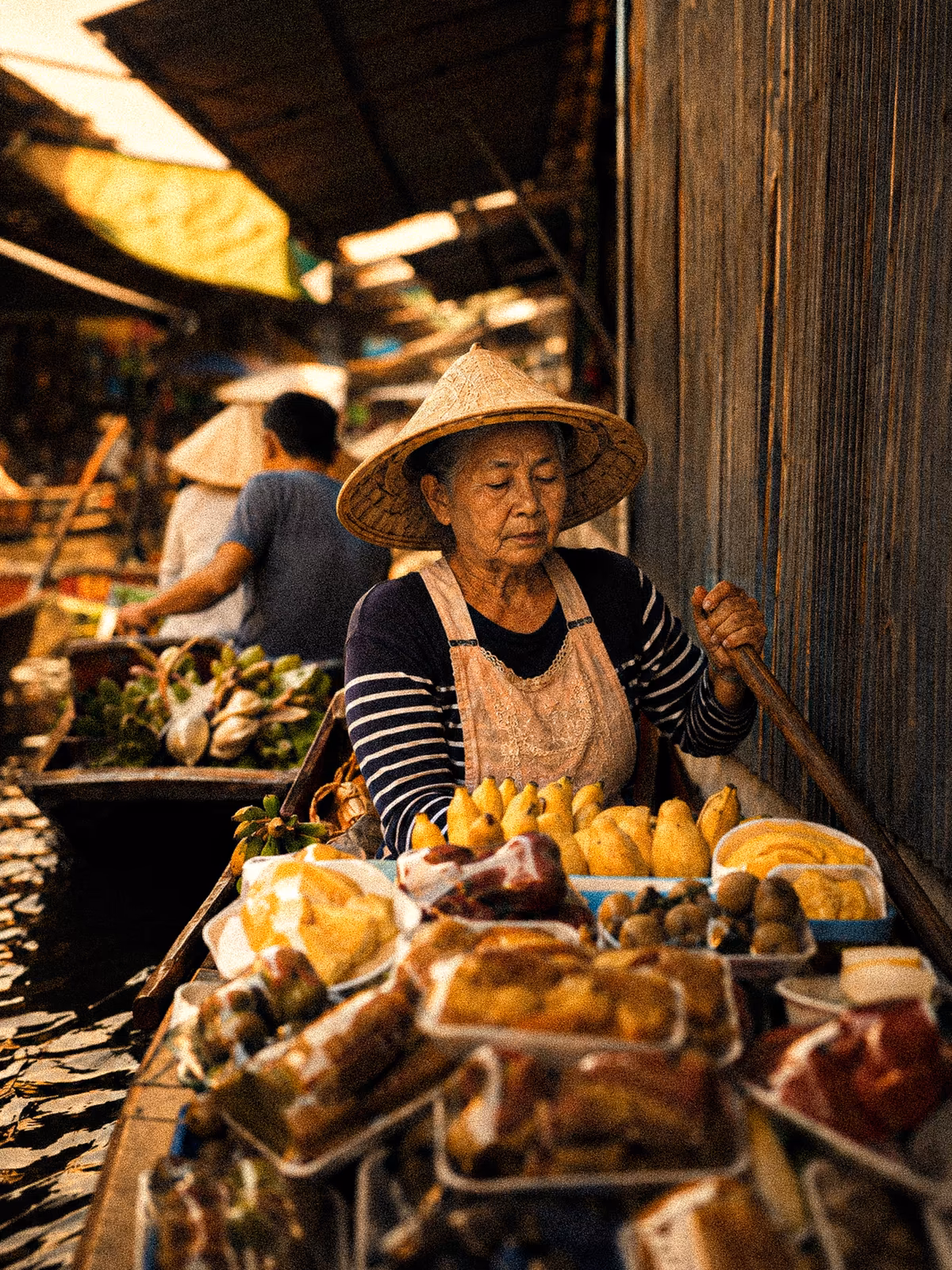 Fruit vendor framed by warm market light in Bangkok