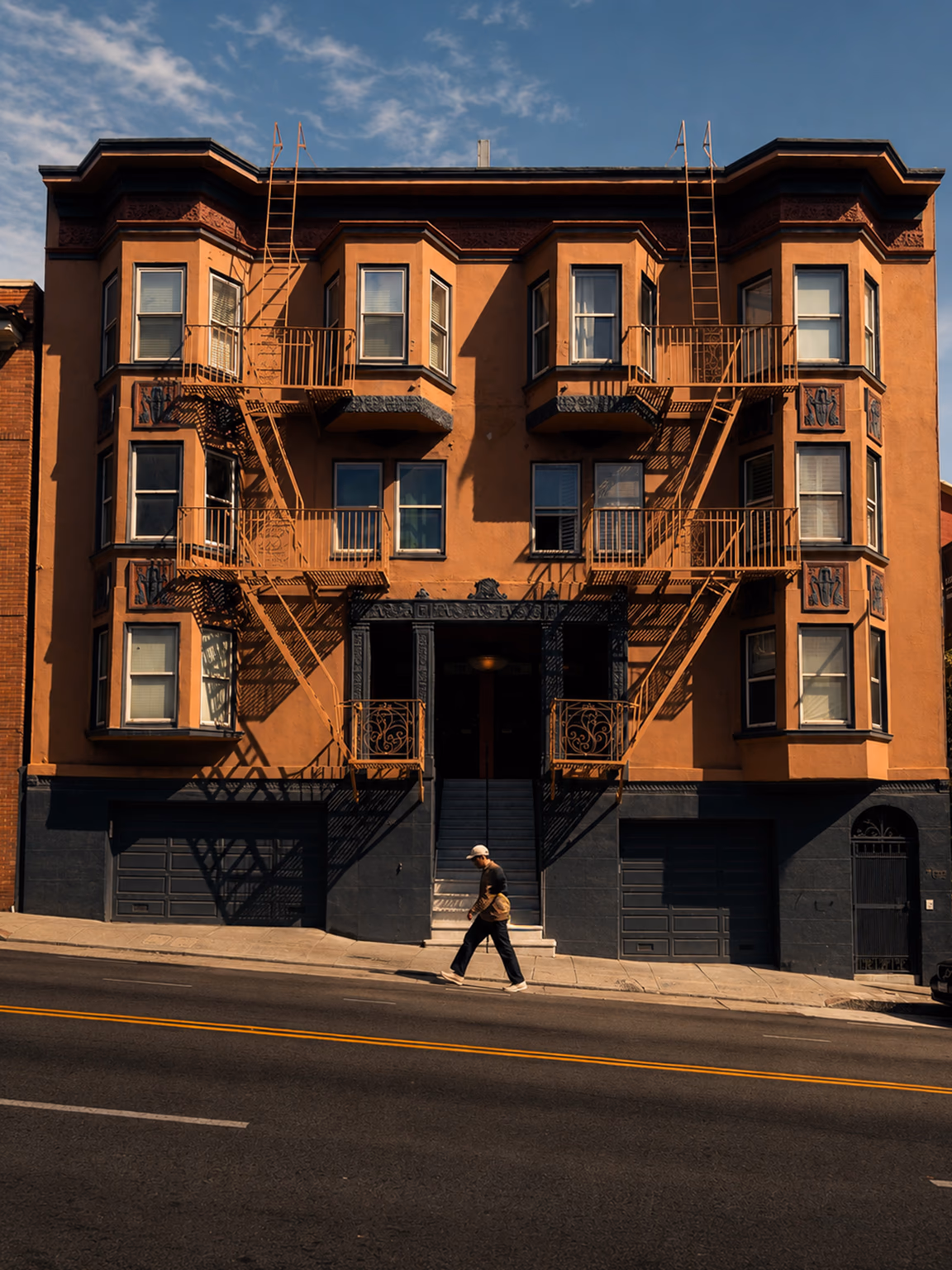 San Francisco facade shaped by afternoon light and fire escapes