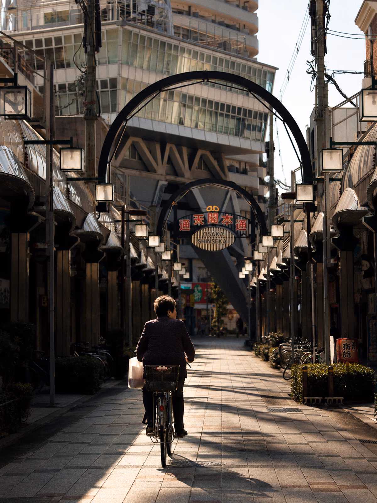 Cyclist crossing a bright street in Osaka