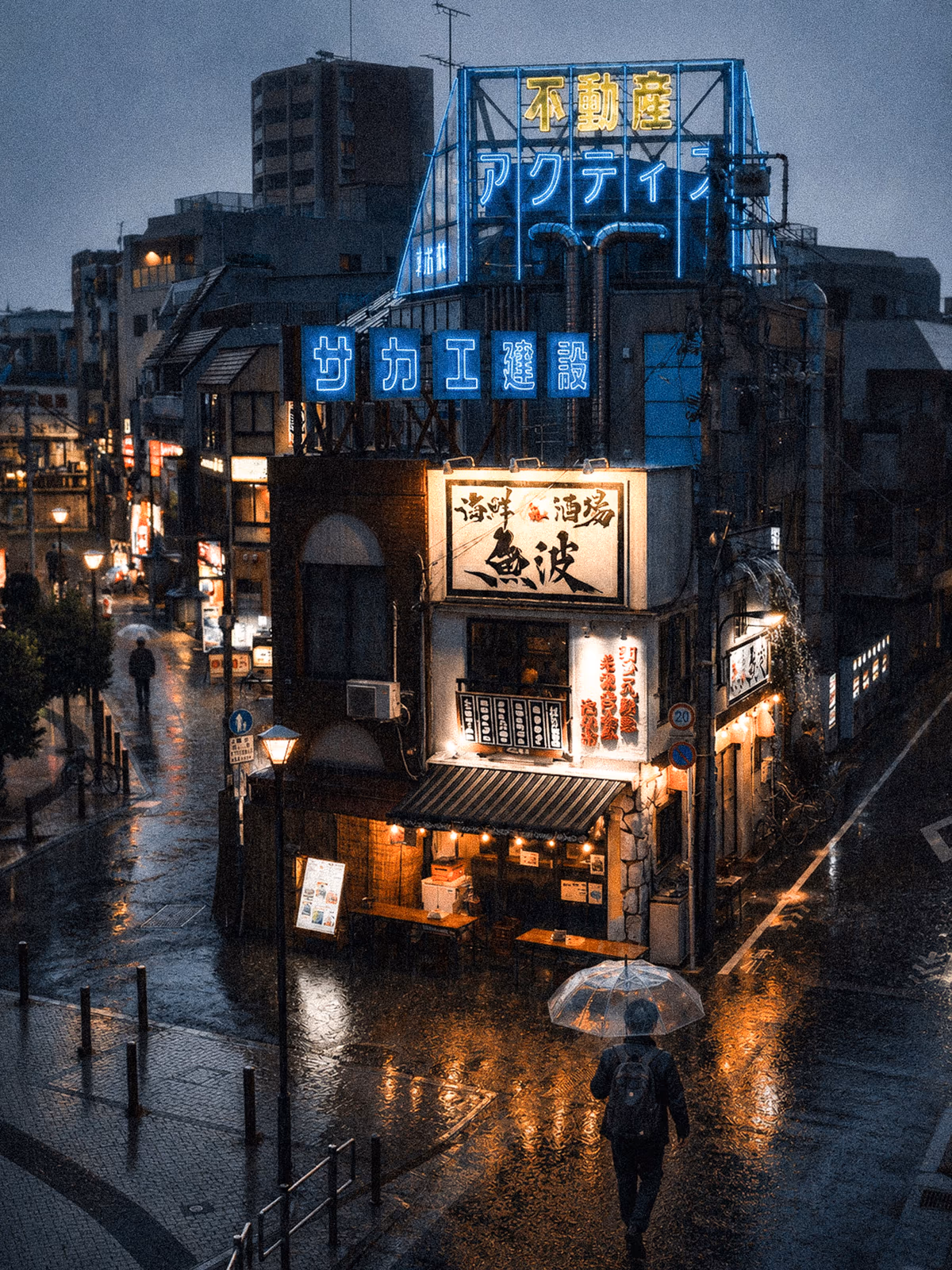 Blue and amber reflections on a rainy Japanese city street
