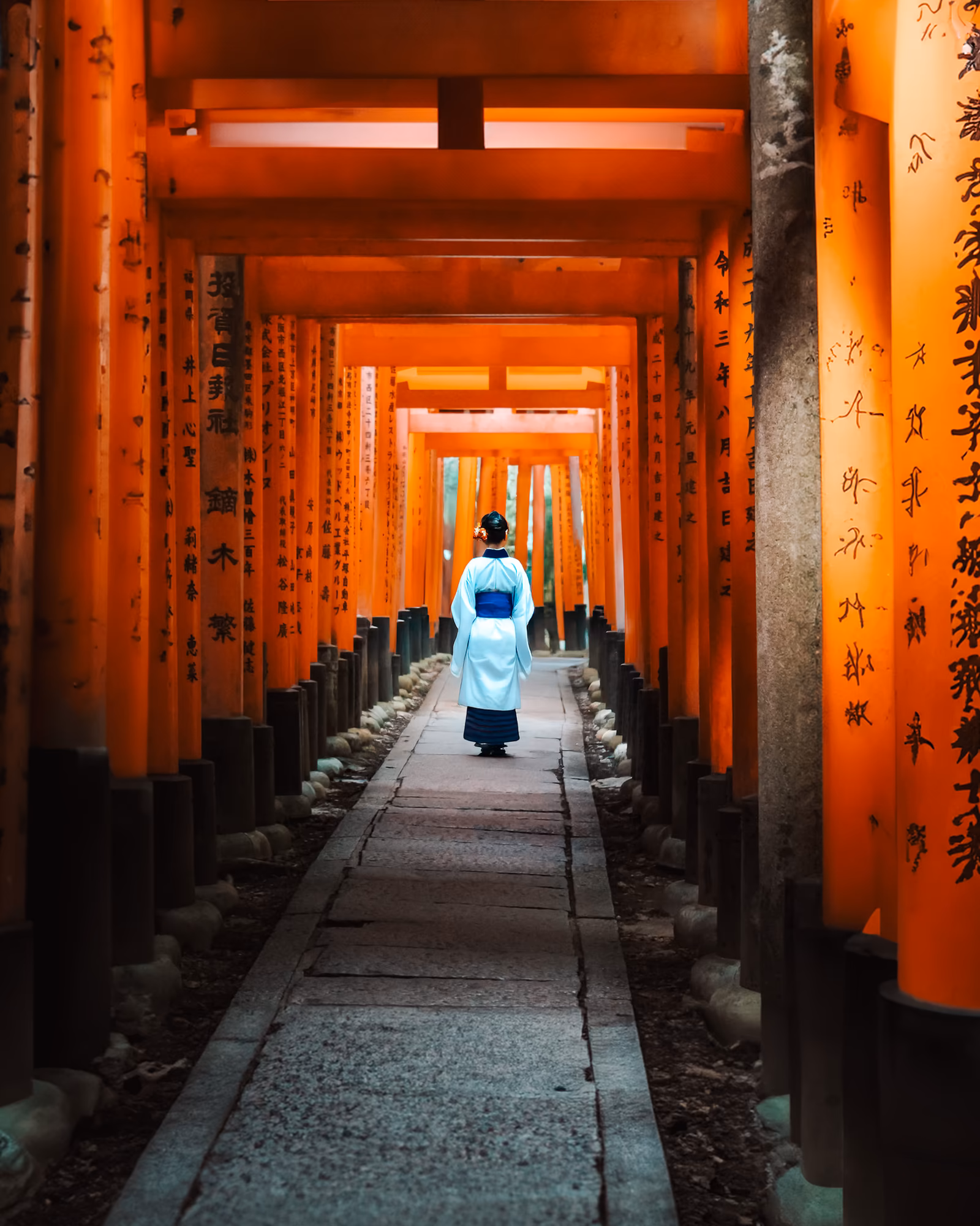 Vermilion torii framed by autumn foliage in Kyoto