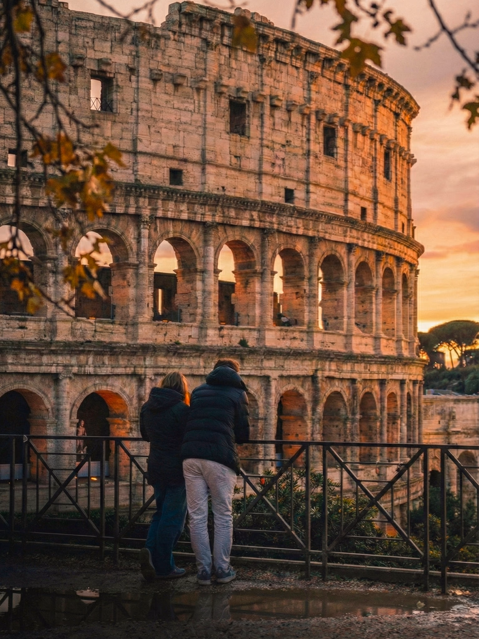 The Colosseum glowing against the evening sky