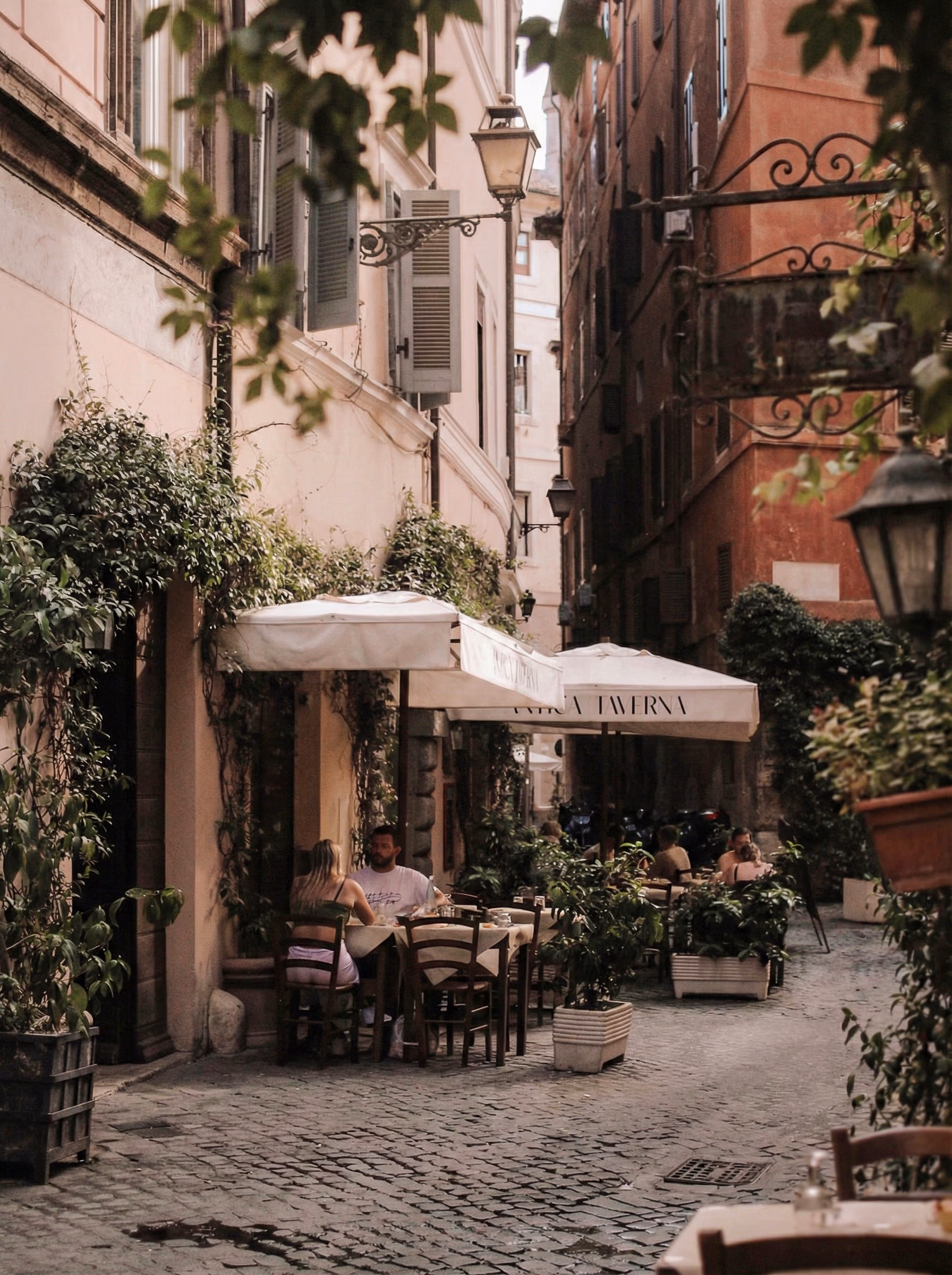A warmly lit street in Trastevere at night