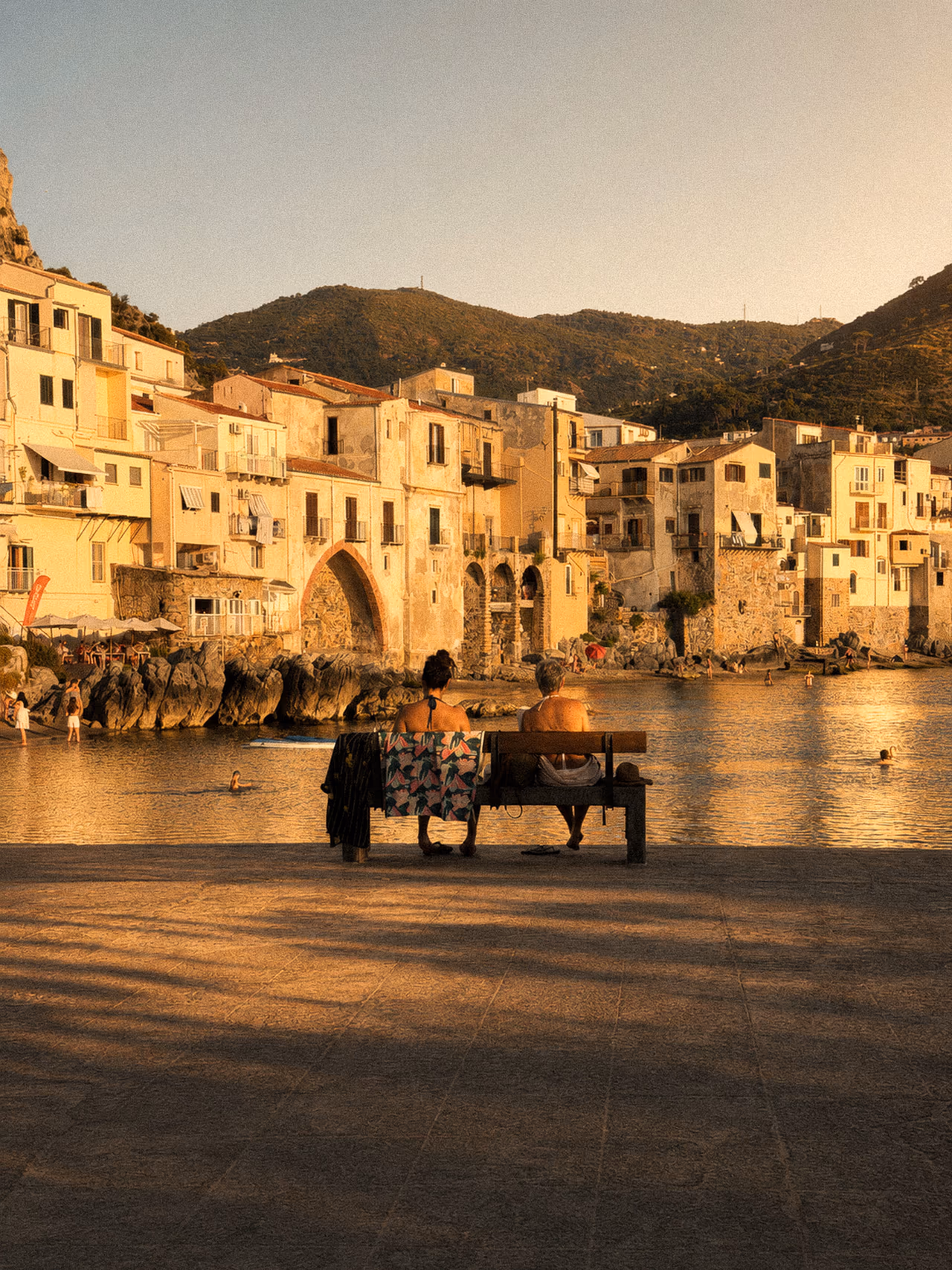 Cefalù waterfront and its historic seafront buildings in warm evening light
