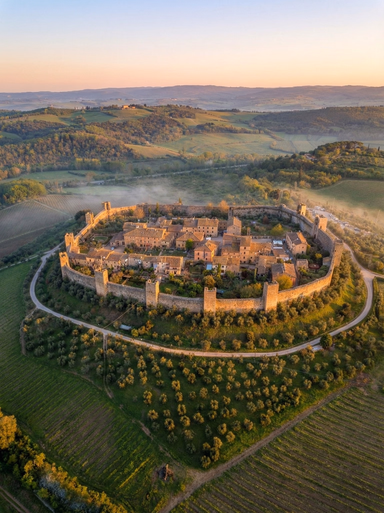 A walled Tuscan hill town seen from above