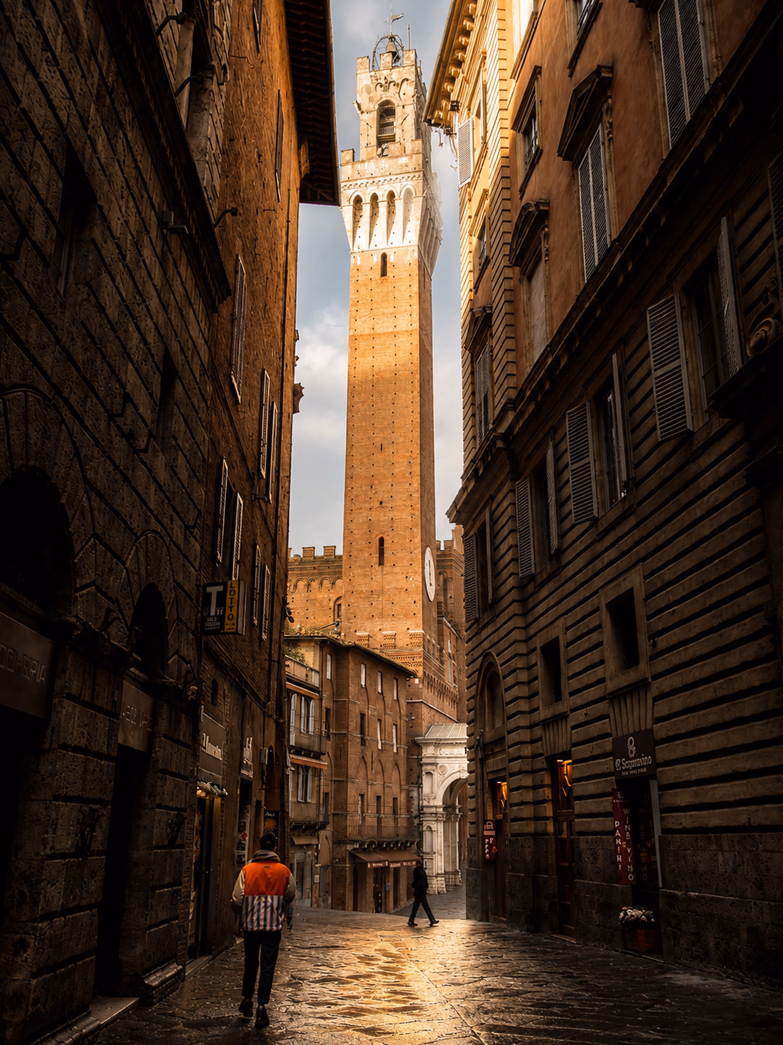 A quiet street in Siena leading towards Torre del Mangia